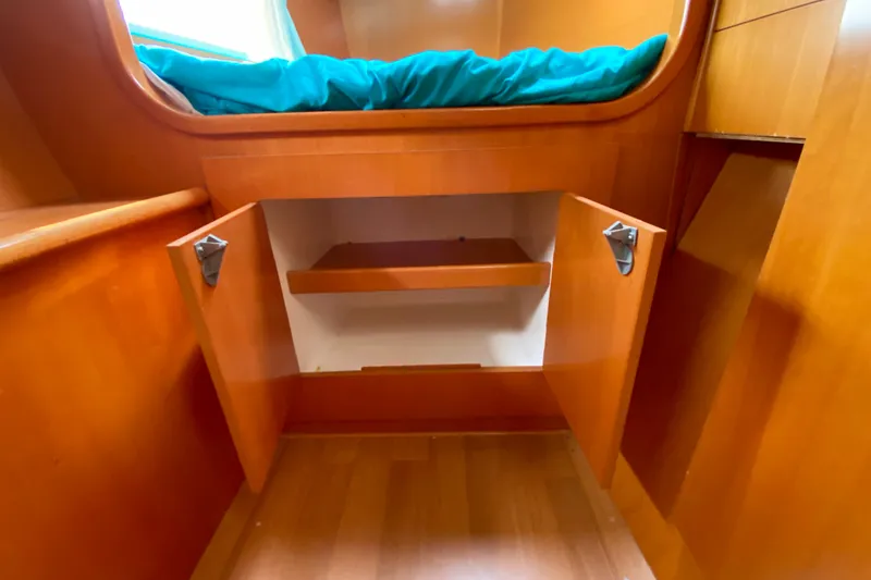 Slide: The Image of Wooden interior storage space on a 2005 Lagoon 380 S2 catamaran. - 113
