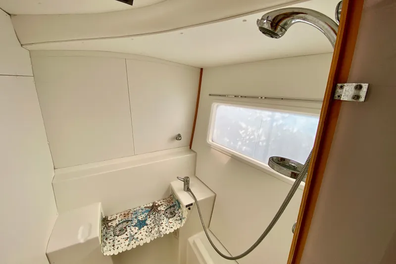 Slide: The Image of Bathroom interior of 2005 Lagoon 380 S2 yacht with shower and window. - 76