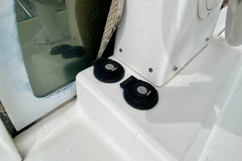 Slide: The Image of Close-up of 2005 Lagoon 380 S2 yacht deck with foot pedals and window reflection. - 146
