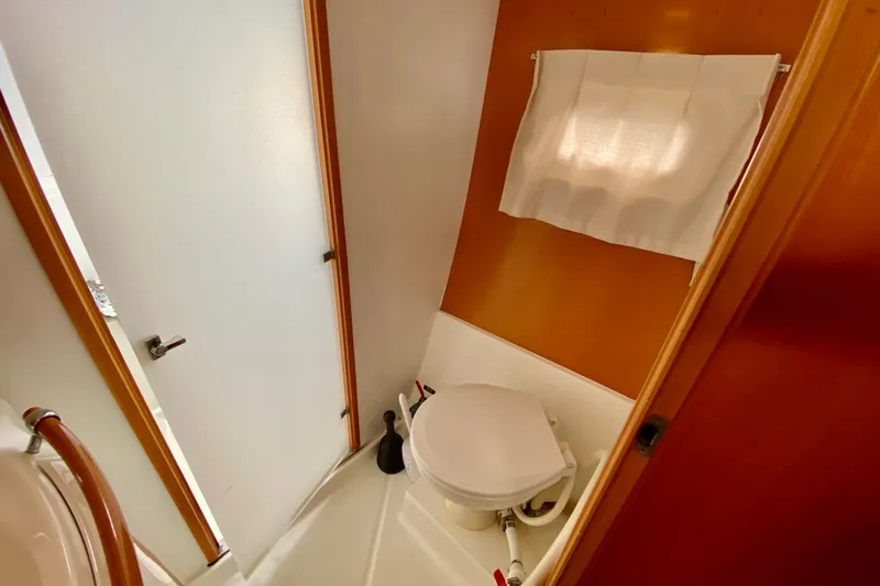Slide: The Image of Bathroom interior of 2005 Lagoon 380 S2 yacht with toilet and frosted door. - 74