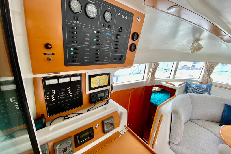 Slide: The Image of Interior of 2005 Lagoon 380 S2 yacht showing control panel and seating area. - 86