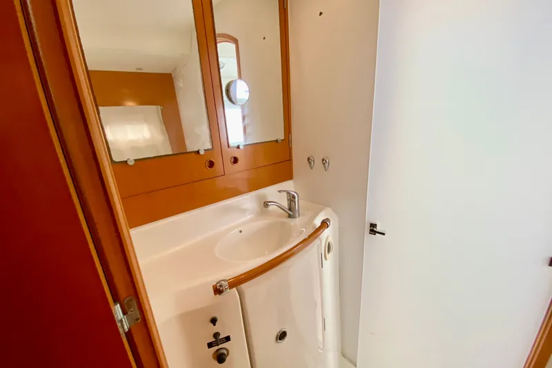 Slide: The Image of Compact bathroom in 2005 Lagoon 380 S2 yacht with sink and mirror. - 75
