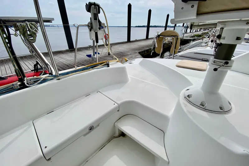 Slide: The Image of 2005 Lagoon 380 S2 catamaran deck view at marina, showcasing sleek design and mooring area. - 34