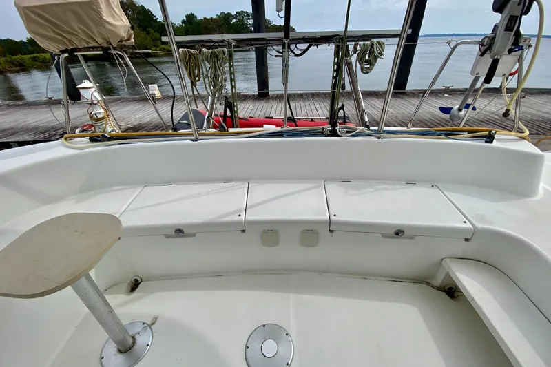 Slide: The Image of Cockpit view of 2005 Lagoon 380 S2 catamaran docked by a serene waterfront. - 33
