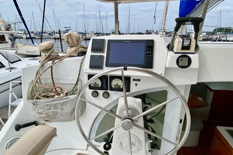 Slide: The Image of Cockpit of 2005 Lagoon 380 S2 catamaran with steering wheel and navigation equipment. - 41