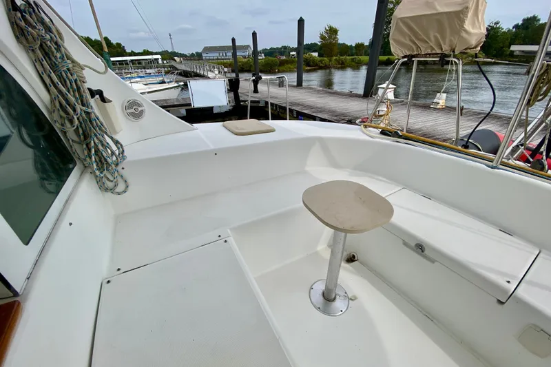 Slide: The Image of Lagoon 380 S2 catamaran cockpit, 2005 model, docked by a serene riverside. - 32