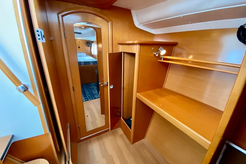 Slide: The Image of Interior of 2005 Lagoon 380 S2 yacht with wooden cabinetry and mirror. - 73