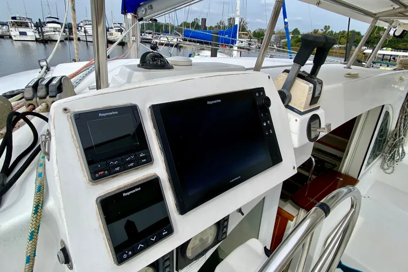 Slide: The Image of Cockpit of 2005 Lagoon 380 S2 catamaran with navigation equipment and steering wheel. - 40
