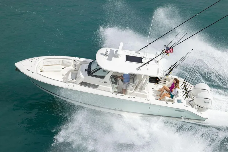 Slide: The Image of Manufacturer Provided Image: 2025 Pursuit S 328 Sport boat cruising on ocean with fishing rods. - 3