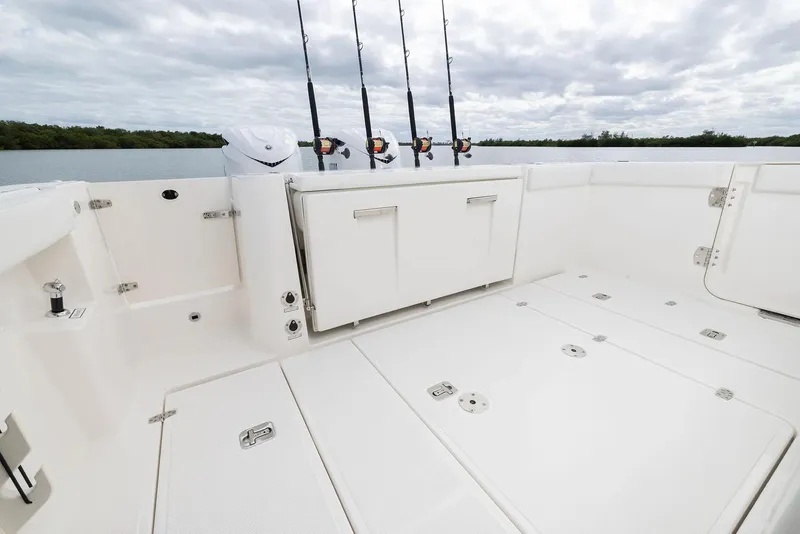Slide: The Image of Manufacturer Provided Image: 2025 Pursuit S 328 Sport boat deck with fishing rods, spacious and sleek design. - 13