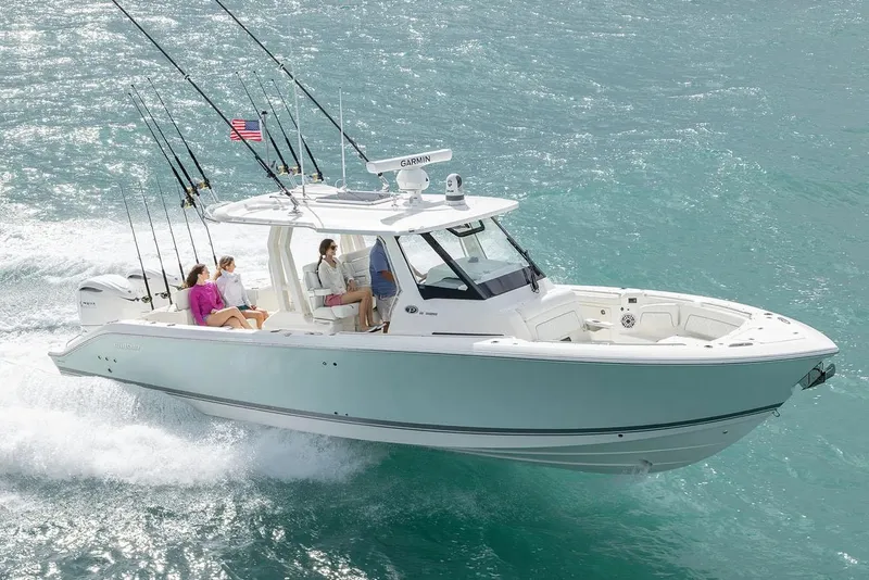 The Image of Manufacturer Provided Image: 2025 Pursuit S 328 Sport boat cruising on turquoise water with passengers onboard. - 0