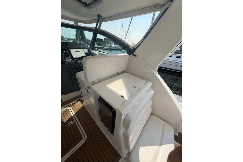 Slide: The Image of Interior of 2001 Tiara Yachts 3800 Open, featuring seating and helm area. - 9
