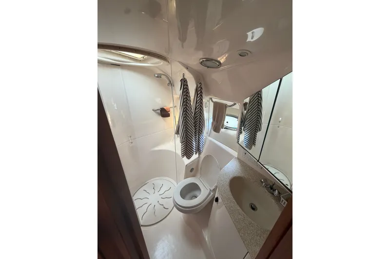 Slide: The Image of Bathroom interior of 2001 Tiara Yachts 3800 Open, featuring toilet, sink, and shower. - 8