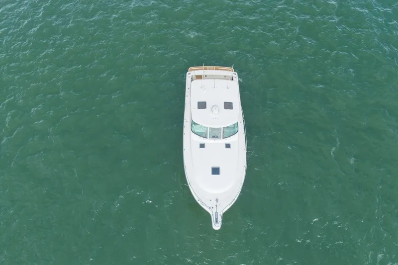 Slide: The Image of Aerial view of 2001 Tiara Yachts 3800 Open on calm green water. - 5