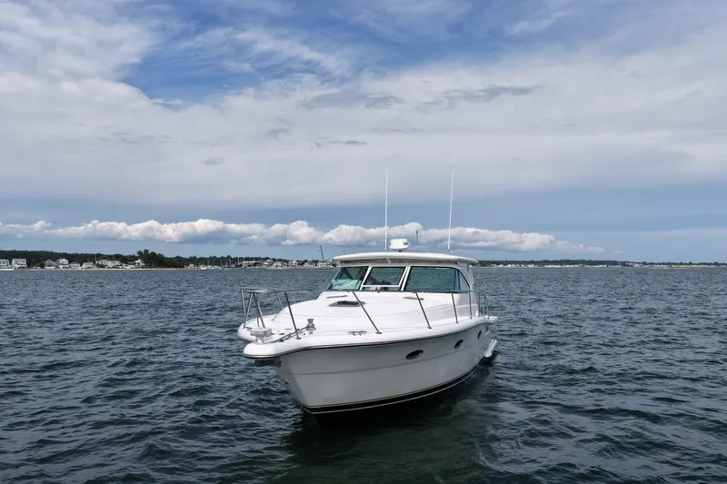 Slide: The Image of 2001 Tiara Yachts 3800 Open on calm water under a cloudy sky. - 3