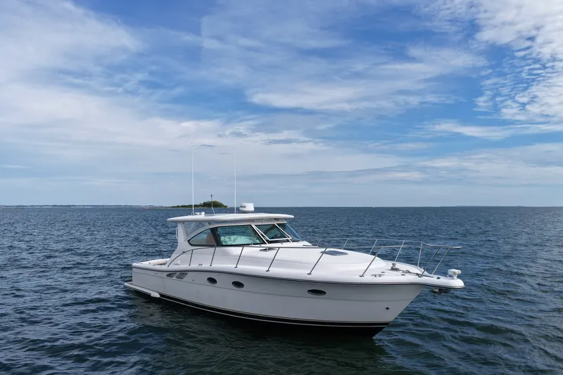 The Image of 2001 Tiara Yachts 3800 Open cruising on calm ocean waters under a blue sky. - 1
