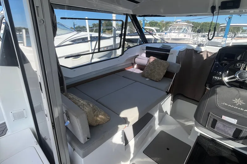 Slide: The Image of Interior of 2020 Jeanneau NC 795 boat with seating and steering area. - 19