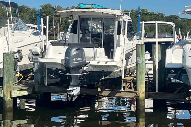Slide: The Image of 2020 Jeanneau NC 795 boat with Yamaha engine docked at marina. - 7