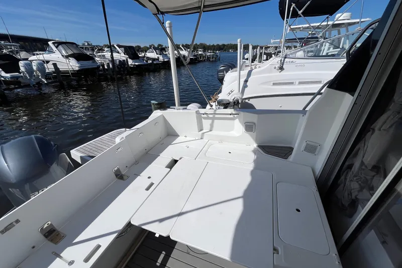 Slide: The Image of 2020 Jeanneau NC 795 boat docked at marina, featuring spacious deck area. - 36