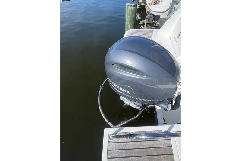 Slide: The Image of Yamaha outboard motor on a 2020 Jeanneau NC 795 boat docked by the water. - 10