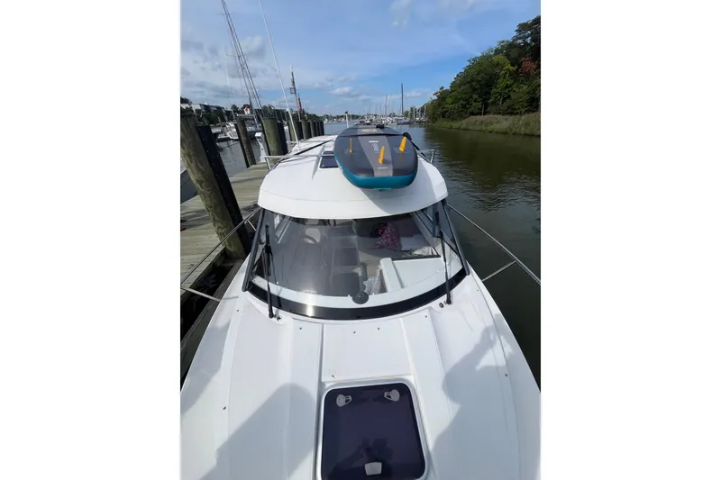 Slide: The Image of 2020 Jeanneau NC 795 boat docked at marina, featuring sleek design and spacious deck. - 3