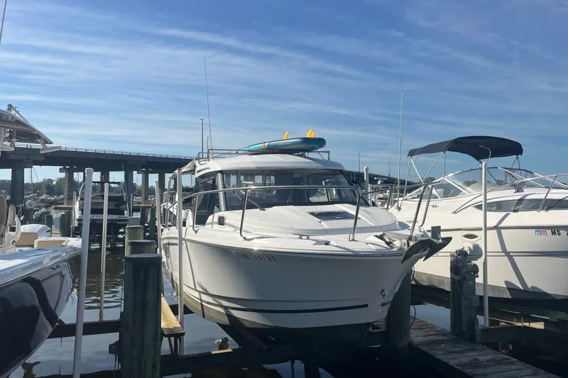 Slide: The Image of 2020 Jeanneau NC 795 boat docked at marina under clear blue sky. - 5