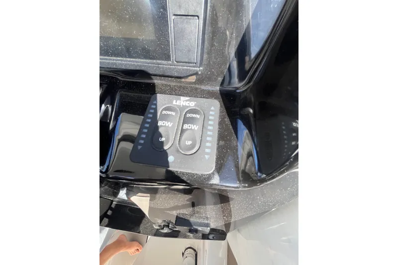 Slide: The Image of Control panel of a 2020 Jeanneau NC 795 boat with Lenco trim tab switches. - 25