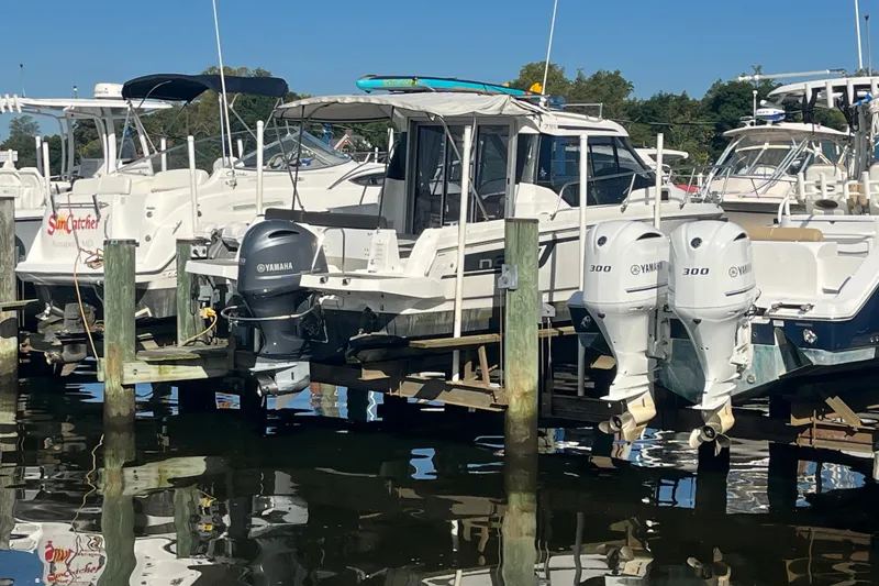 Slide: The Image of 2020 Jeanneau NC 795 boat docked with Yamaha outboard motor. - 6