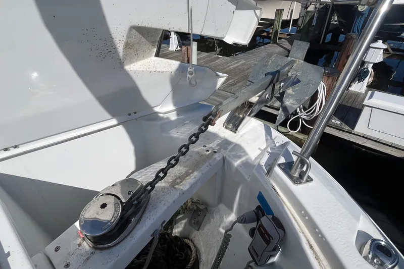 Slide: The Image of Anchor and chain mechanism on a 2020 Jeanneau NC 795 boat at a dock. - 16