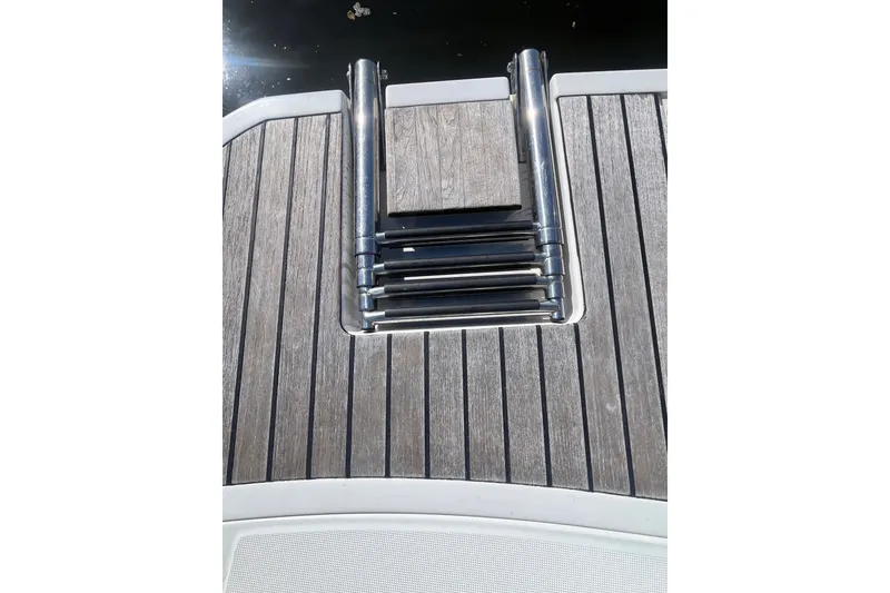 Slide: The Image of Teak deck with retractable ladder on 2020 Jeanneau NC 795 boat. - 9