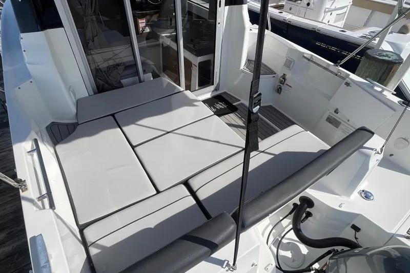 Slide: The Image of 2020 Jeanneau NC 795 boat deck with cushioned seating and modern design. - 11