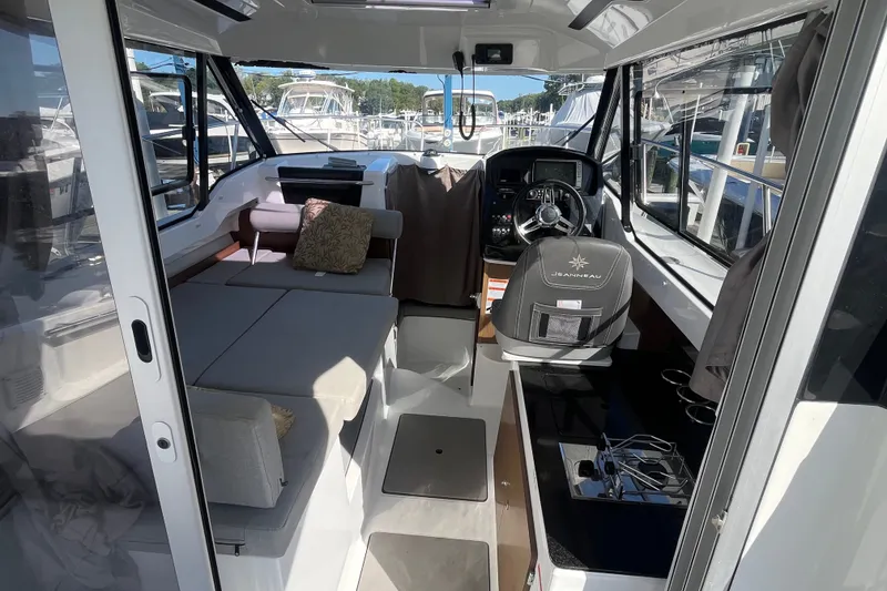 Slide: The Image of Interior of 2020 Jeanneau NC 795 boat, featuring seating and helm station. - 18