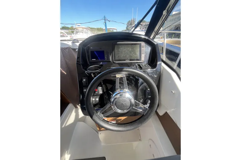 Slide: The Image of Steering console of 2020 Jeanneau NC 795 boat with navigation equipment. - 24