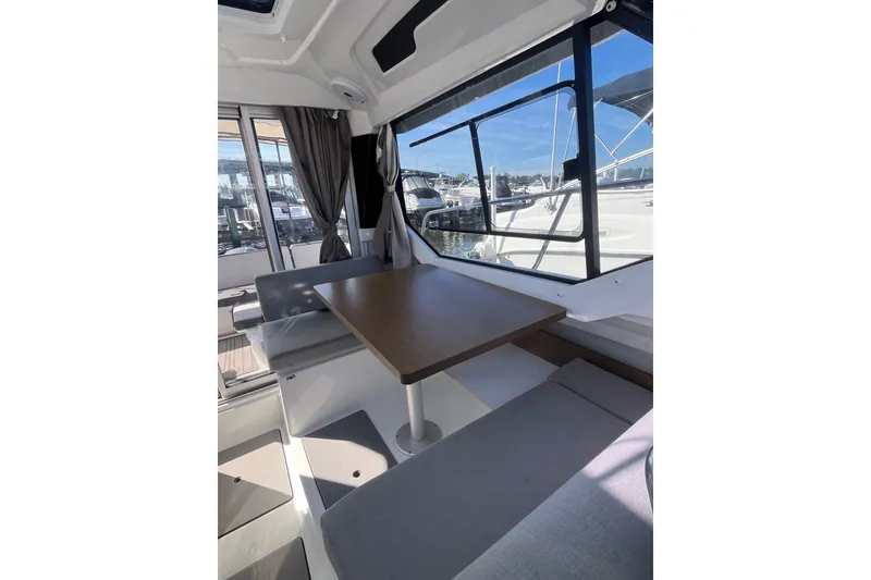 Slide: The Image of Interior of 2020 Jeanneau NC 795 boat with dining area and large windows. - 33