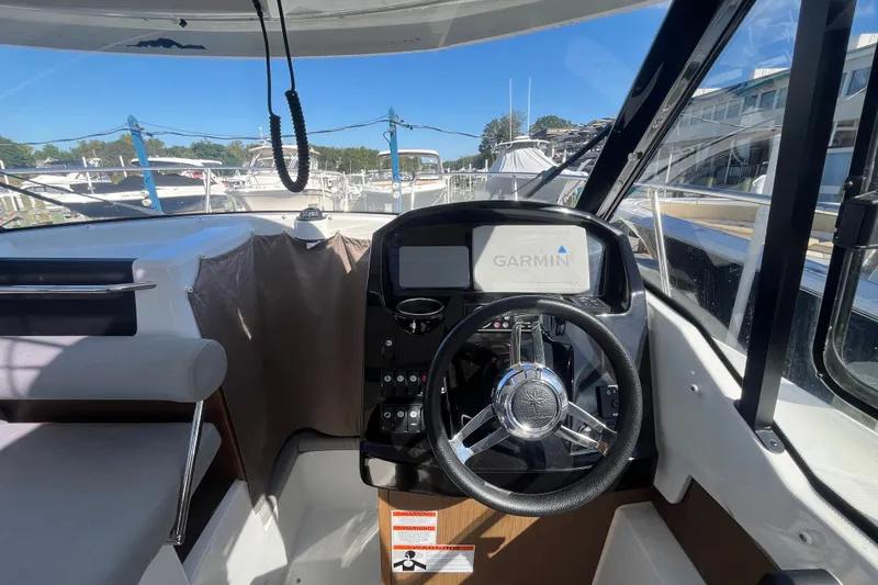 Slide: The Image of 2020 Jeanneau NC 795 helm with Garmin navigation, docked at marina. - 26