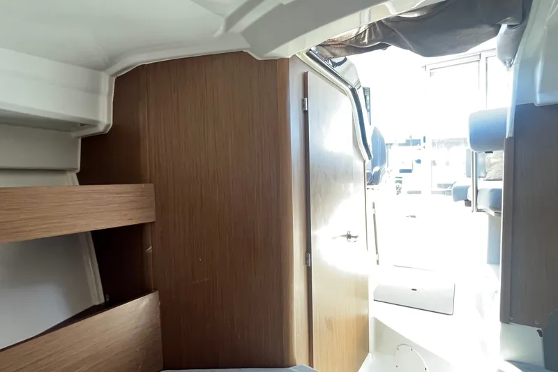 Slide: The Image of Interior view of 2020 Jeanneau NC 795 boat, featuring wooden cabinetry and seating area. - 30