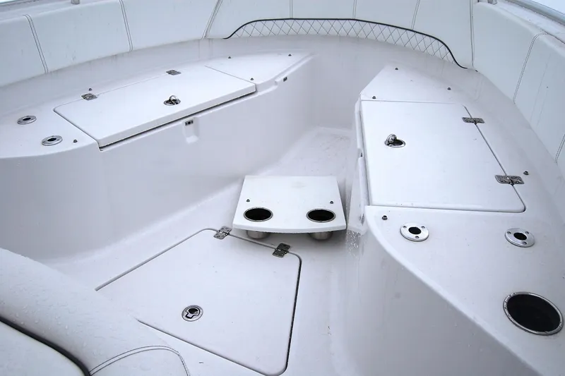 Slide: The Image of 2023 Sportsman Open 242 Center Console boat interior with storage compartments. - 14