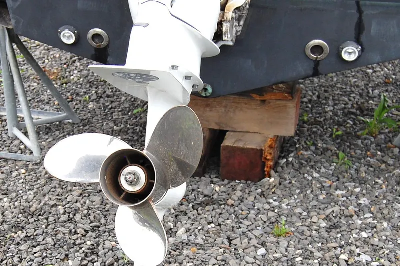 Slide: The Image of Propeller of 2023 Sportsman Open 242 Center Console on gravel surface. - 19
