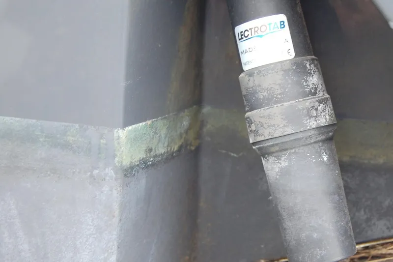 Slide: The Image of Close-up of a 2023 Sportsman Open 242 Center Console boat component with Lectrotab label. - 18