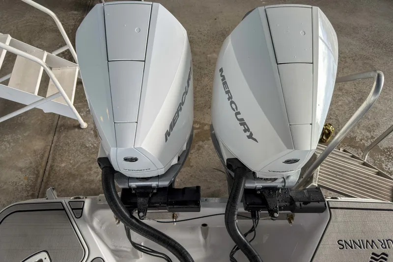Slide: The Image of Twin Mercury outboard engines on a 2026 Four Winns H9 OB boat, viewed from above. - 24