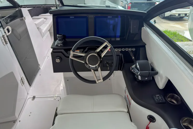 Slide: The Image of Interior cockpit of 2026 Four Winns H9 OB boat with modern steering and controls. - 7