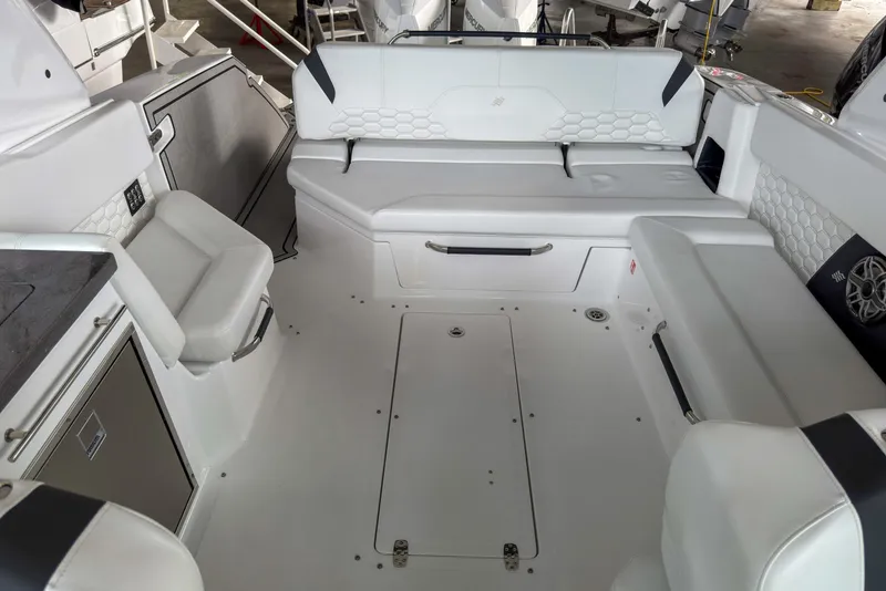 Slide: The Image of Interior of 2026 Four Winns H9 OB boat with white seating and modern design. - 15