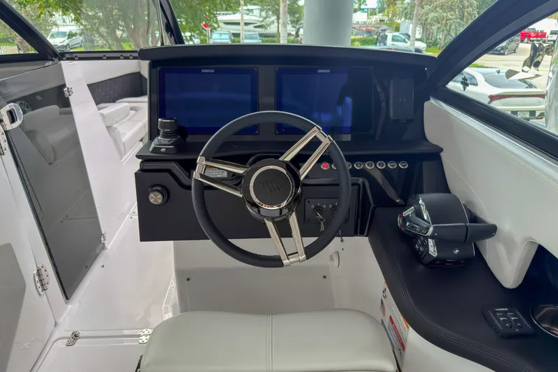 Slide: The Image of 2026 Four Winns H9 OB boat cockpit with modern steering and dual displays. - 6