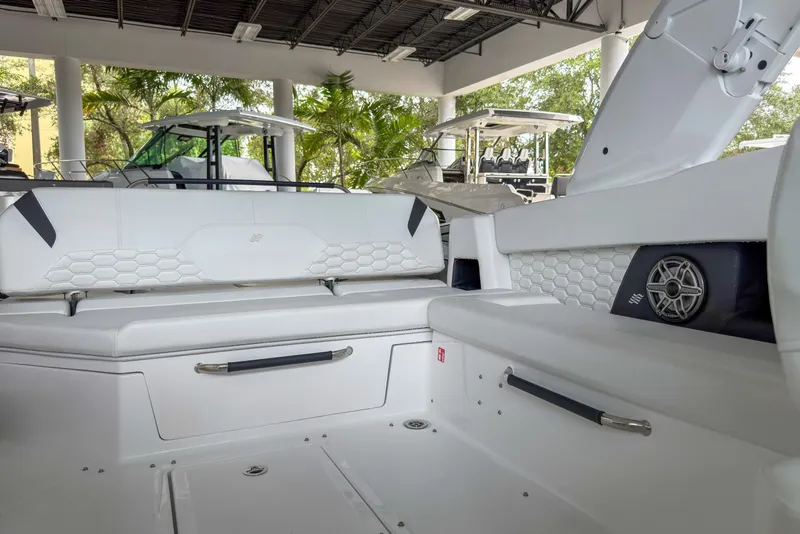 Slide: The Image of 2026 Four Winns H9 OB boat interior with white seating and modern design. - 16