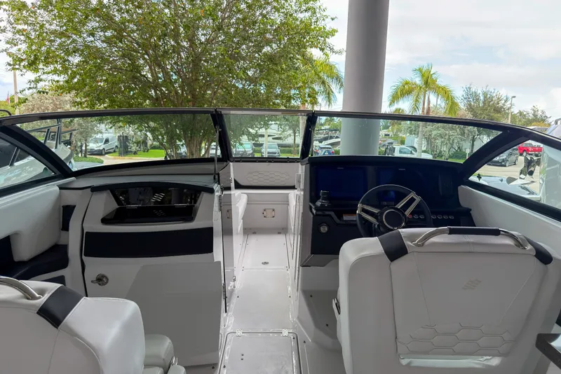 Slide: The Image of Interior view of 2026 Four Winns H9 OB boat, featuring sleek design and modern controls. - 5