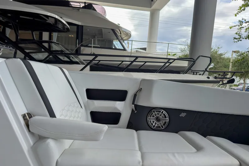 Slide: The Image of 2026 Four Winns H9 OB boat interior with white seating and speaker detail. - 23