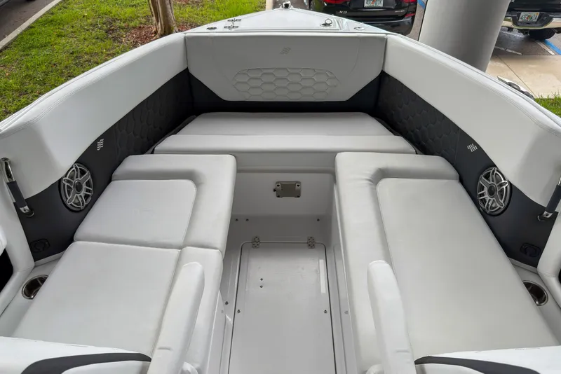 Slide: The Image of Interior seating of 2026 Four Winns H9 OB boat, featuring sleek white upholstery and modern design. - 19