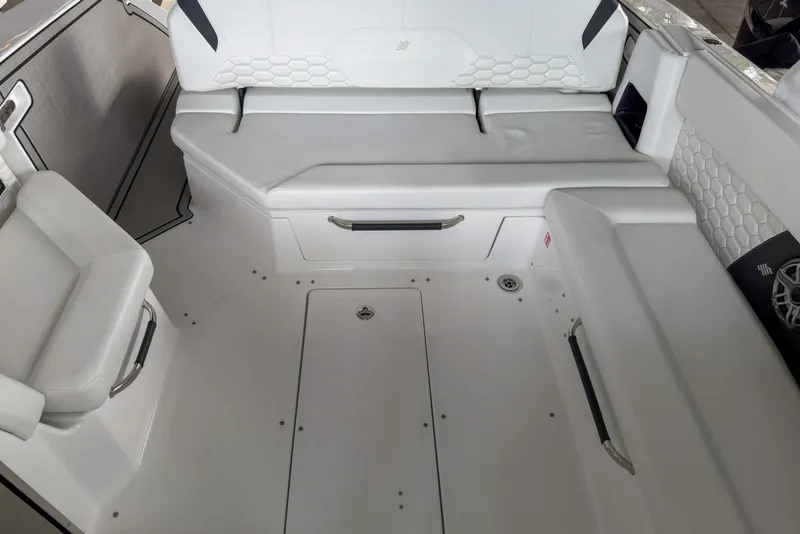 Slide: The Image of Interior of 2026 Four Winns H9 OB boat with white seating and modern design. - 18