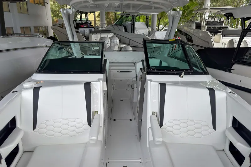 Slide: The Image of 2026 Four Winns H9 OB boat interior with sleek white seating and modern design. - 21