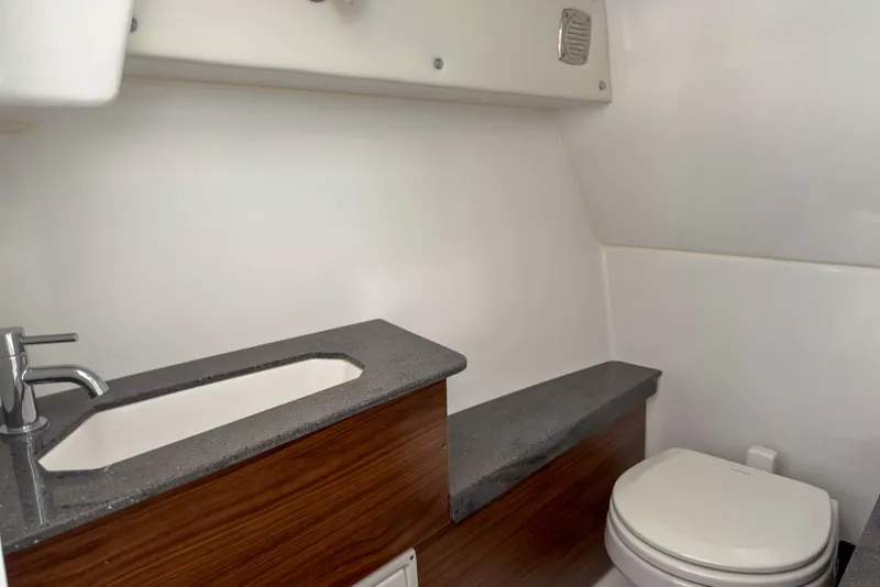 Slide: The Image of Modern bathroom interior in 2026 Four Winns H9 OB boat, featuring sleek sink and toilet. - 13